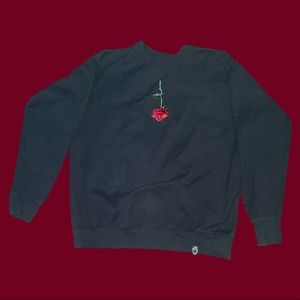 Large sewn upside rose black crewneck sweater